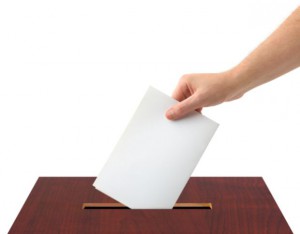 Hand with ballot and box